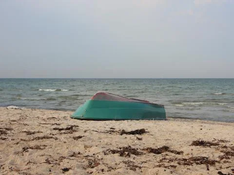 Sand Beach with Upside Down Rowing Boat Stock Photos