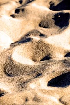 Sand of a beach with waves Stock Photos