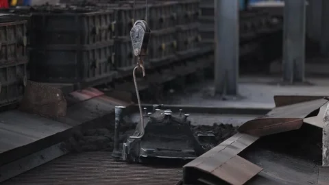 Sand is being separated from the finished casting part. Stock Footage 252569745