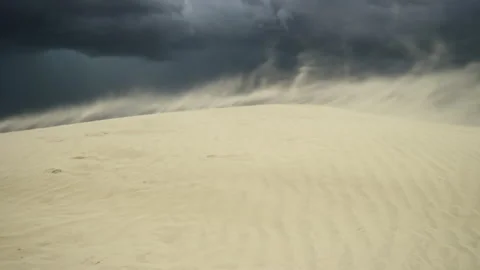 Sand blasts across dune during dramatic imposing thunderstorm Stock Footage 247986038