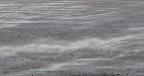 Sand blowing across a mud flat in an estuary in north Wales. Stock Footage 337424785
