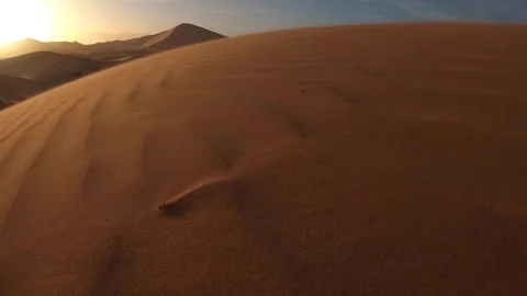 Sand blowing over Erg Chebbi dunes in wind, Sahara desert in Morocco Stock Footage 273514662