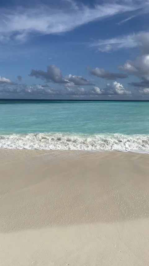 Sand blue ocean tide waves cloudy sky tropical paradise Stock Footage 200920086