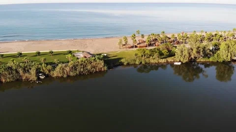 Sand braid between sea and river in Belek. Hotel beach in palm grove. Stock Footage 172358143