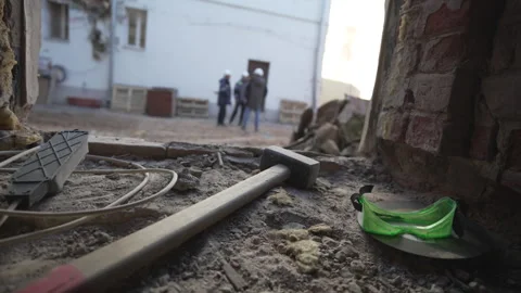 Sand broken concrete and tools rest near building exit Видео 316089971