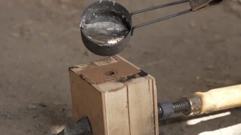 Sand casting molten aluminum. Casting molten aluminum into wood mold. Liquid  Stock Footage 140322868