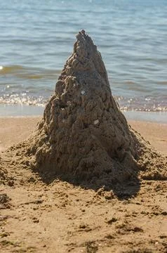 Sand castle on the beach Stock Photos