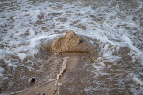 Sand castle mountain collapsing Stock Photos