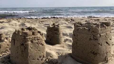 Sand Castles on the Beach with Waves in Slow Motion Stock Footage 305767488