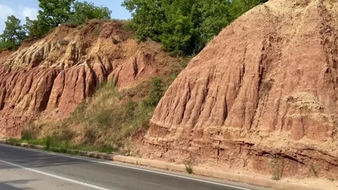 The sand cliffs above the highway look very beautiful. Macedonia. Stock Footage 290170857