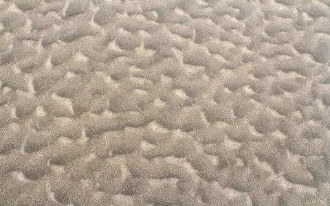 Sand closeup full frame abstract sand closeup pattern seen on a beach in N... Stock Photos