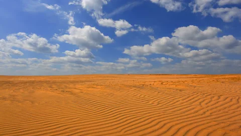 Sand desert and a blue cloudy sky time lapse scene Stock Footage 177371941
