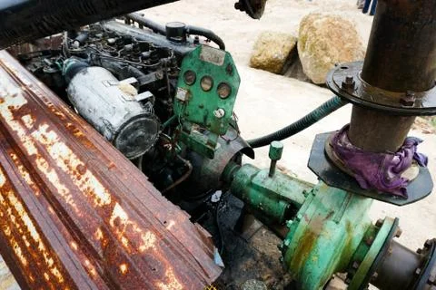 Sand dredging machine removing sand in river from river bank - Image Stock Photos
