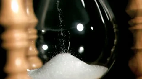 Sand dropping in super slow motion from an egg timer Stock Footage 11412540