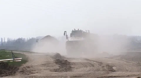 Sand dumper approaching through a dust cloud Stock Footage 49649378