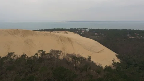 Sand dune bordered by forest and sea at Dunes Of Pilat, France Stock Footage 102507577
