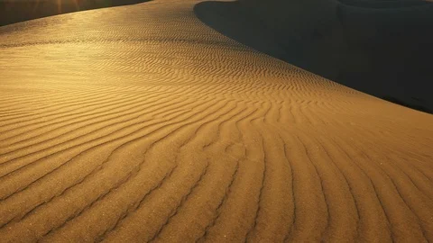 Sand dune with a pattern in the sunset sun rays in a desert. Sand grains Stock Footage 128797961