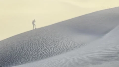 Sand dune shadow of walking man Stock Footage 255303029