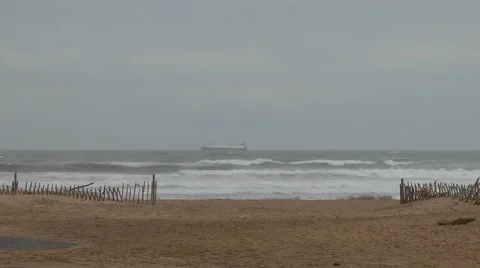 Sand dunes and deserted beach cargo ship on horizon Stock Footage 1097185