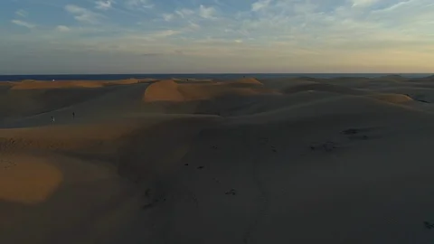 Sand Dunes and the Sea - Reverse Drone shot Stock Footage 100708835