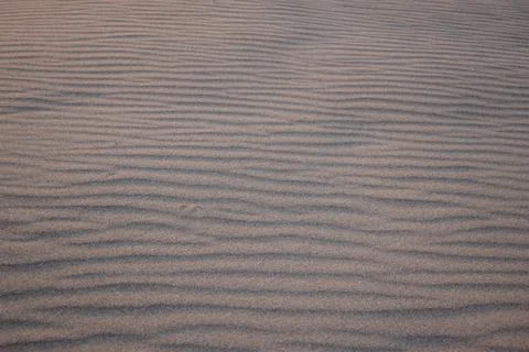 Sand dunes created by the wind. Lay flat Stock Photos