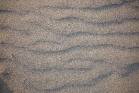 Sand dunes created by the wind. Lay flat Stock Photos