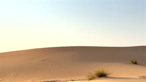 Sand dunes line road as shadows grow longer in evening desert. Golden light Stock-Footage 284551985