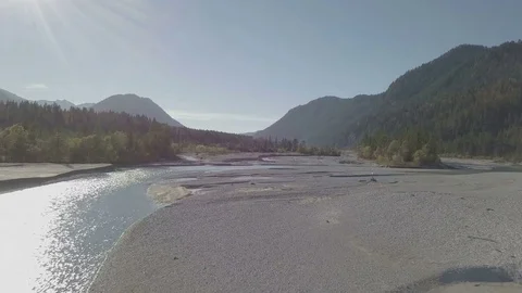 Sand dunes next to the river in the mountains Aerial Stock Footage 83823360