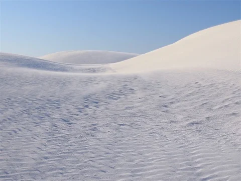 Sand dunes with sand blowing in strong wind under blue sky Stock-Footage 80288721