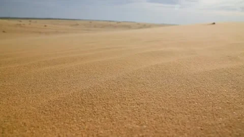Sand dunes shift under sunlight, showcasing texture and patterns in desert Stock Footage 340251395