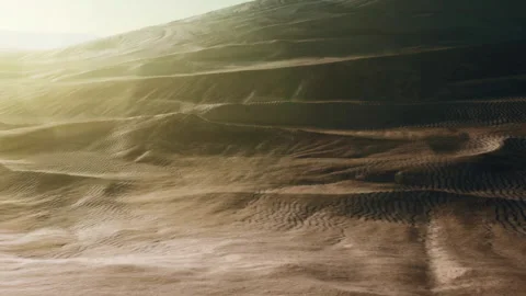 Sand dunes stretch across a desert landscape during sunset hours Stock Footage 345058962