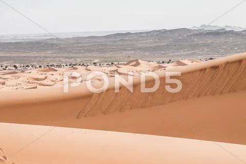 Sand dunes at sunset in the sahara in morocco Stock Photos
