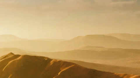 Sand dunes under a sunset sky with distant hills in the background Stock Footage 342815142