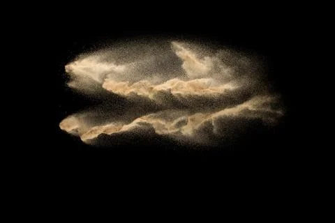 Sand explosion isolated on black background. Freeze motion of sandy dust. Stock Photos