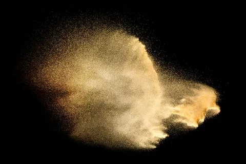 Sand explosion isolated on black background. Freeze motion of sandy dust. Stock Photos