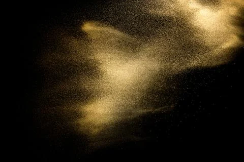 Sand explosion isolated on black background. Freeze motion of sandy dust. Stock Photos