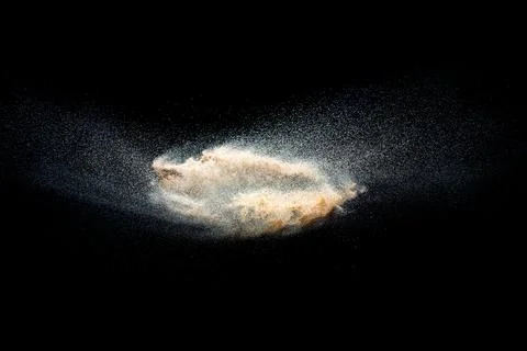 Sand explosion isolated on black background. Freeze motion of sandy dust. Foto stock