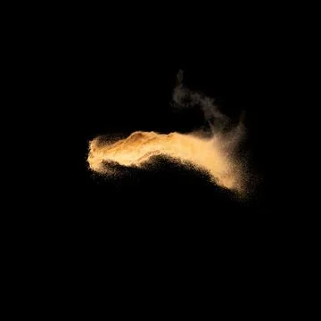Sand explosion isolated on black background. Freeze motion of sandy dust. Stock Photos