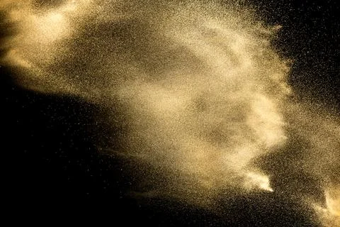 Sand explosion isolated on black background. Freeze motion of sandy dust sp.. Stock Photos