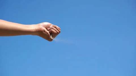 Sand falling from hand and gone with the wind over the blue skies Stock Footage 36440485