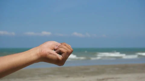Sand falling from hand and gone with the wind over the blue skies Stock Footage 36441182