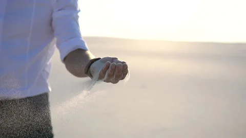 Sand is falling from the hands of a businessman Stock Footage 138604445