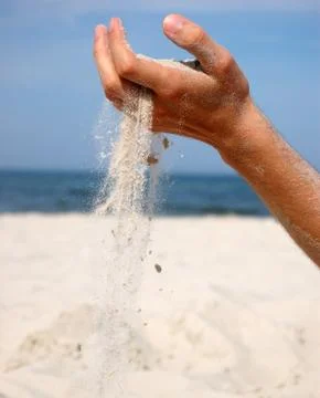 Sand falling from the man's hand Stock Photos