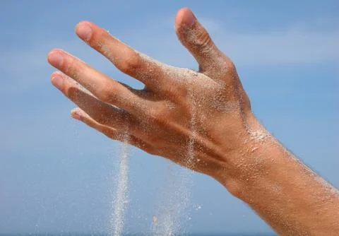 Sand falling from the man's hand Stock Photos
