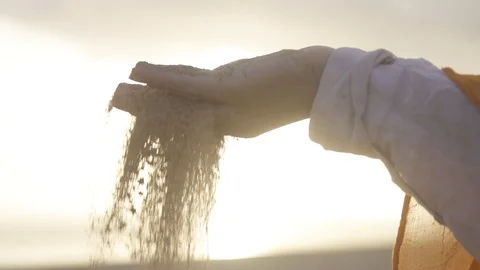 Sand falling through a woman's hand in desert Stock Footage 85818113