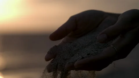 Sand Falling Through Woman's Hands at Beach During Sunset Stock Footage 270297955