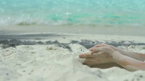 Sand falling from a womans hands in the caribbean Video stock 66422045