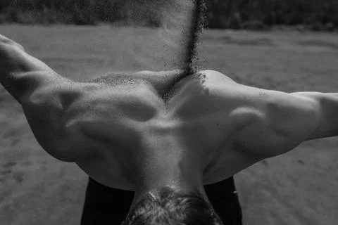 Sand falls on the man's back Stock Photos