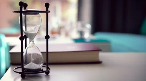 Sand falls quickly through an hourglass Stock Footage 63064579