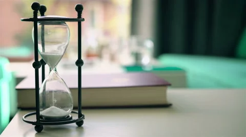 Sand falls quickly through an hourglass Video stock 63361630
